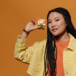 Young happy woman with a Rubik's cube in her right hand.