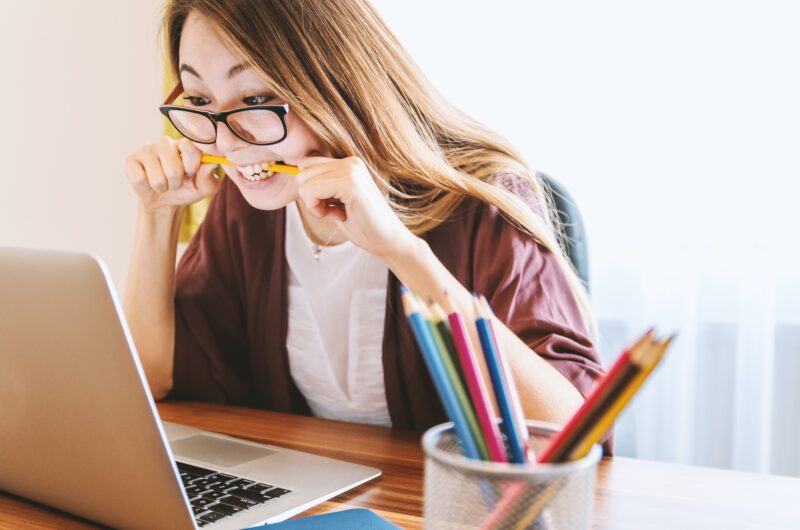 Woman is spoiled and bites on pencil, she does not know what to do, freelancing or a regular job.