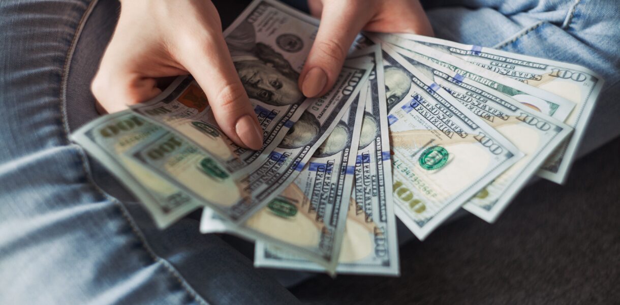 Girl holding American Dollar Bills