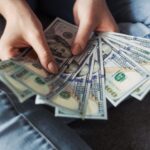 Girl holding American Dollar Bills